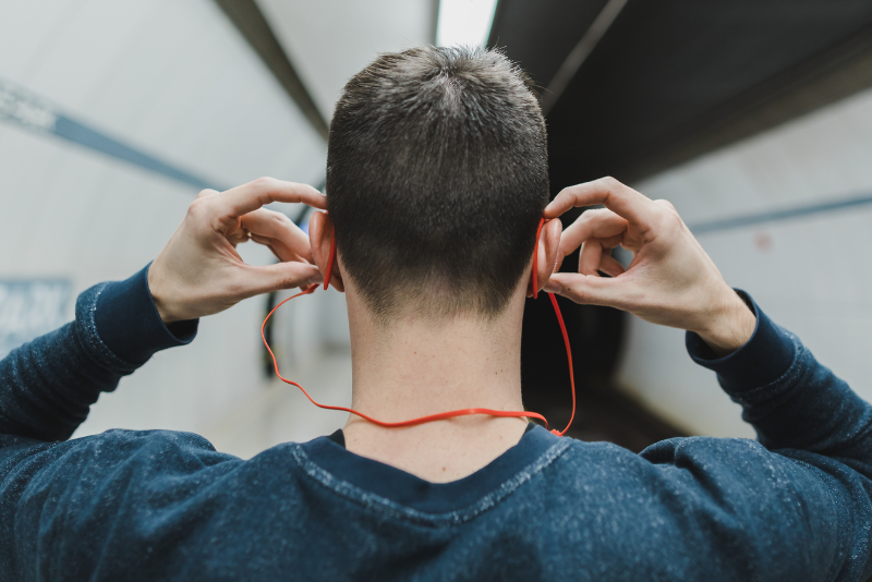 Picture features a commuter wearing headphones