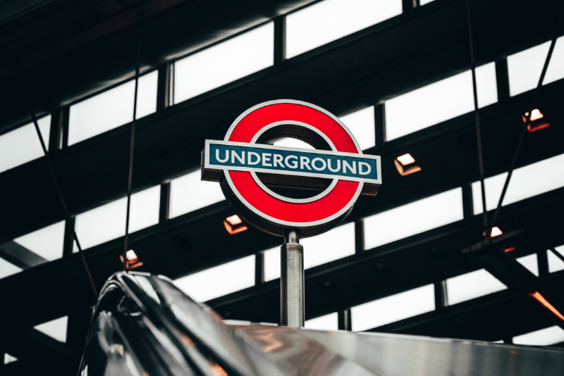 Pictures shows the London underground logo at the top of an escalator