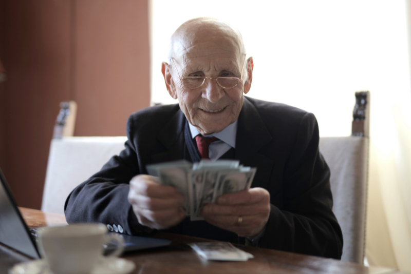 A pensioner with a stack of money.