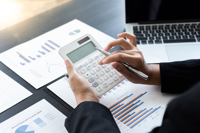 A white calculator and some financial documents.