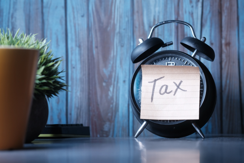 Tax sticky note on an alarm clock.