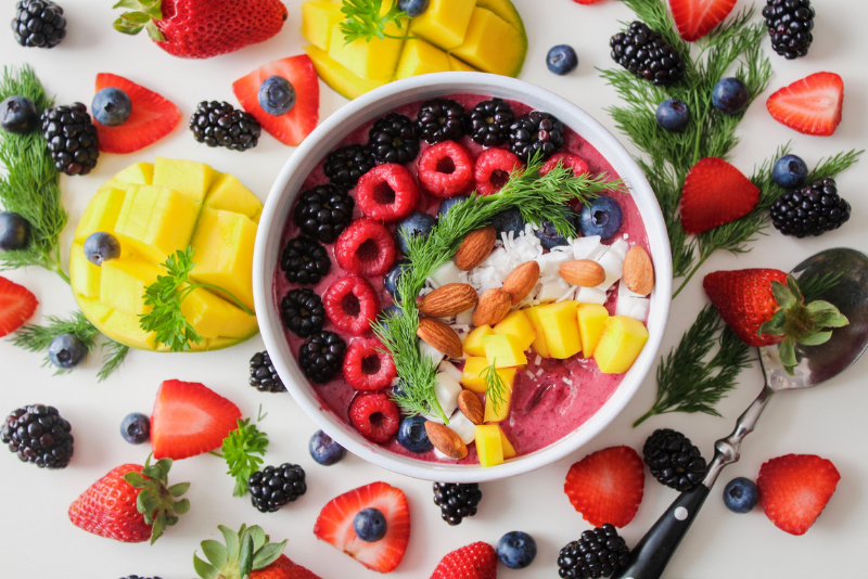 Acai bowl surrounded by fruits