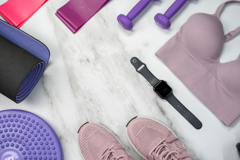 A selection of gym items including training, gym mat, watch and sports bra.
